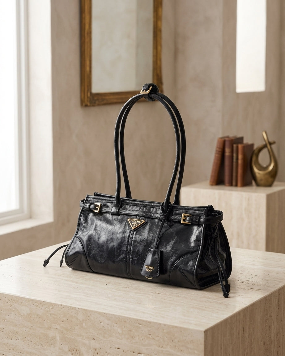 Prada Bonnie medium bag in black antiqued leather with enamel triangle logo, double handles and drawstring sides